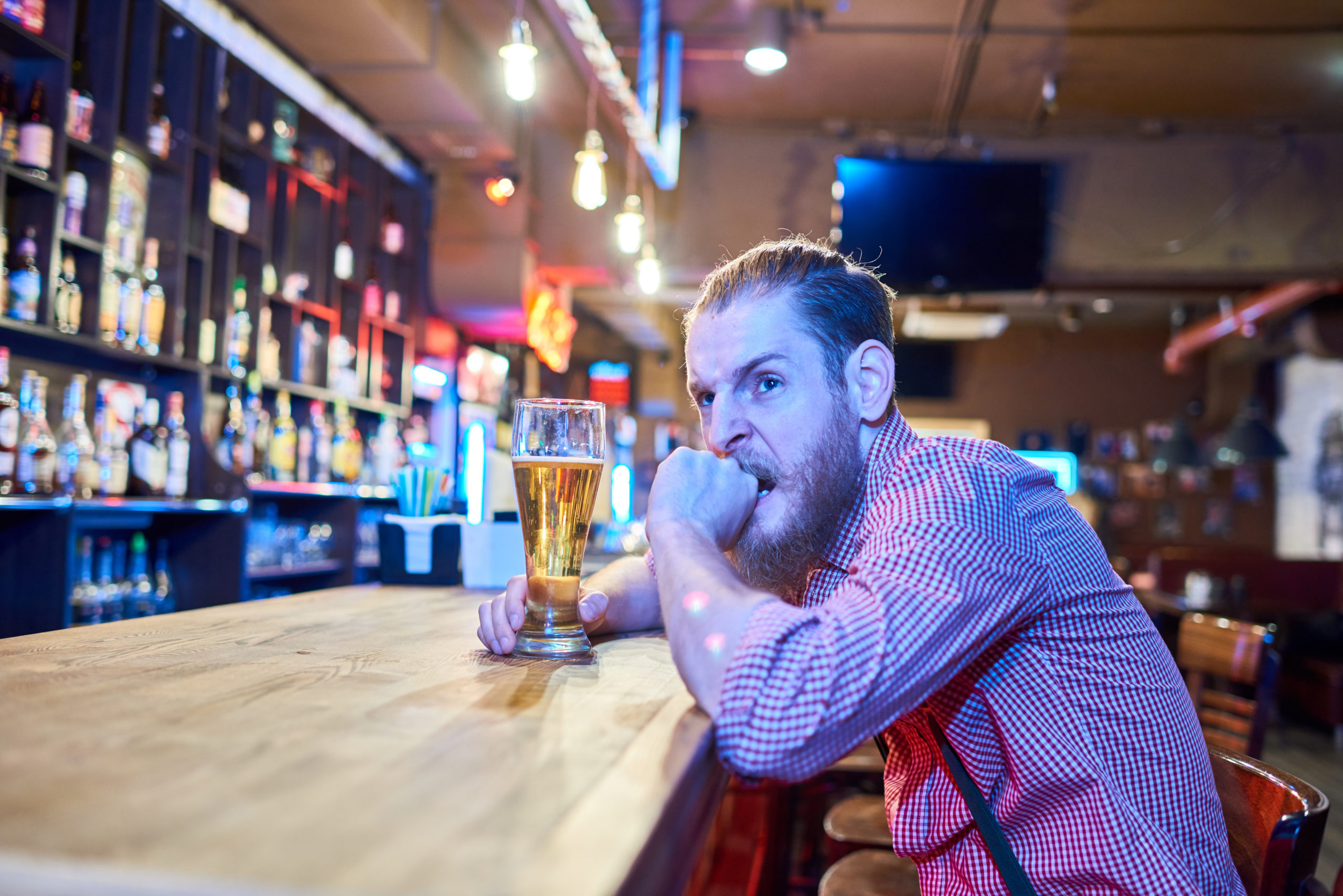 anxious man sitting alone at the bar