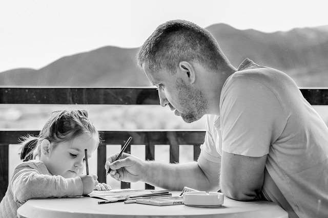 dad and daughter at the table with homework