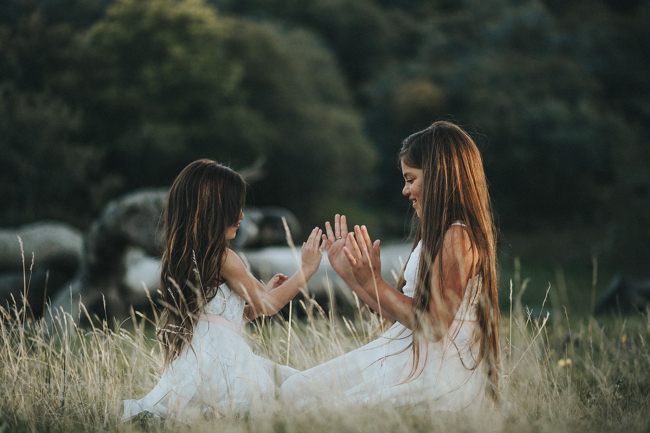 happy girls playing patty cake