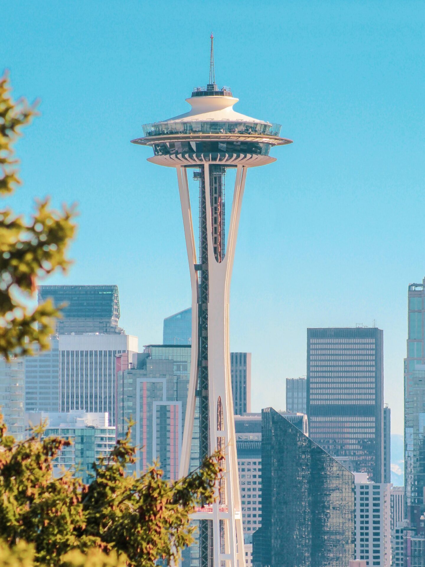 A daytime photo of the Seattle Space Needle against a blue sky.